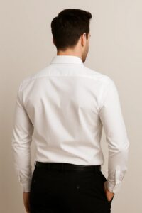 Man wearing a classic white long-sleeve dress shirt with button-down front and pointed collar