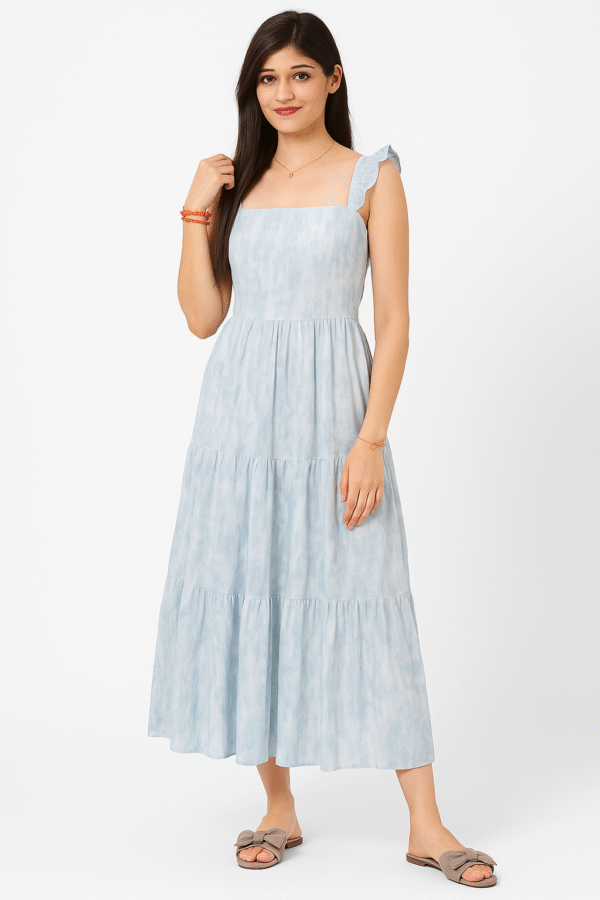 Front view of a woman wearing a sky blue tiered maxi dress with ruffle sleeves Back view of a lace-up tie-back sleeveless summer dress in light blue