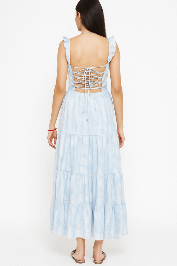 Front view: Woman in blue tie-dye maxi dress with ruffle straps Back view: Woman showing lace-up back detail of maxi dress